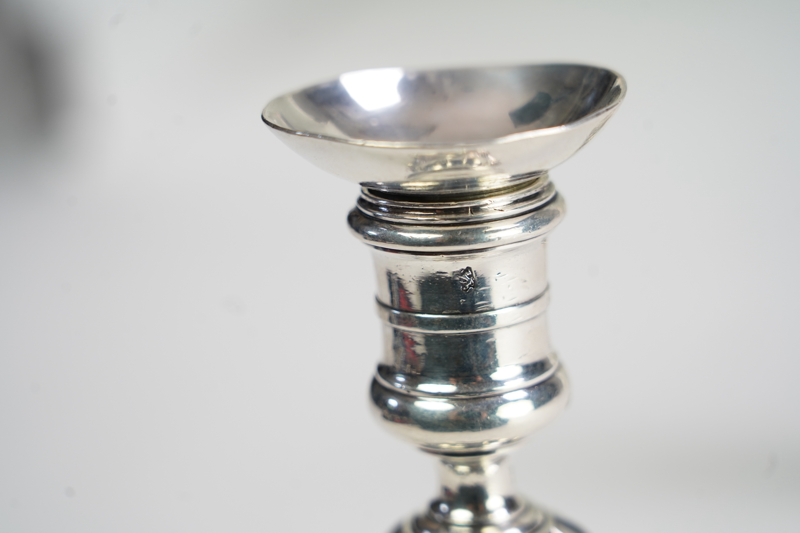 A pair of George II cast silver candlesticks, by Susannah Hatfield